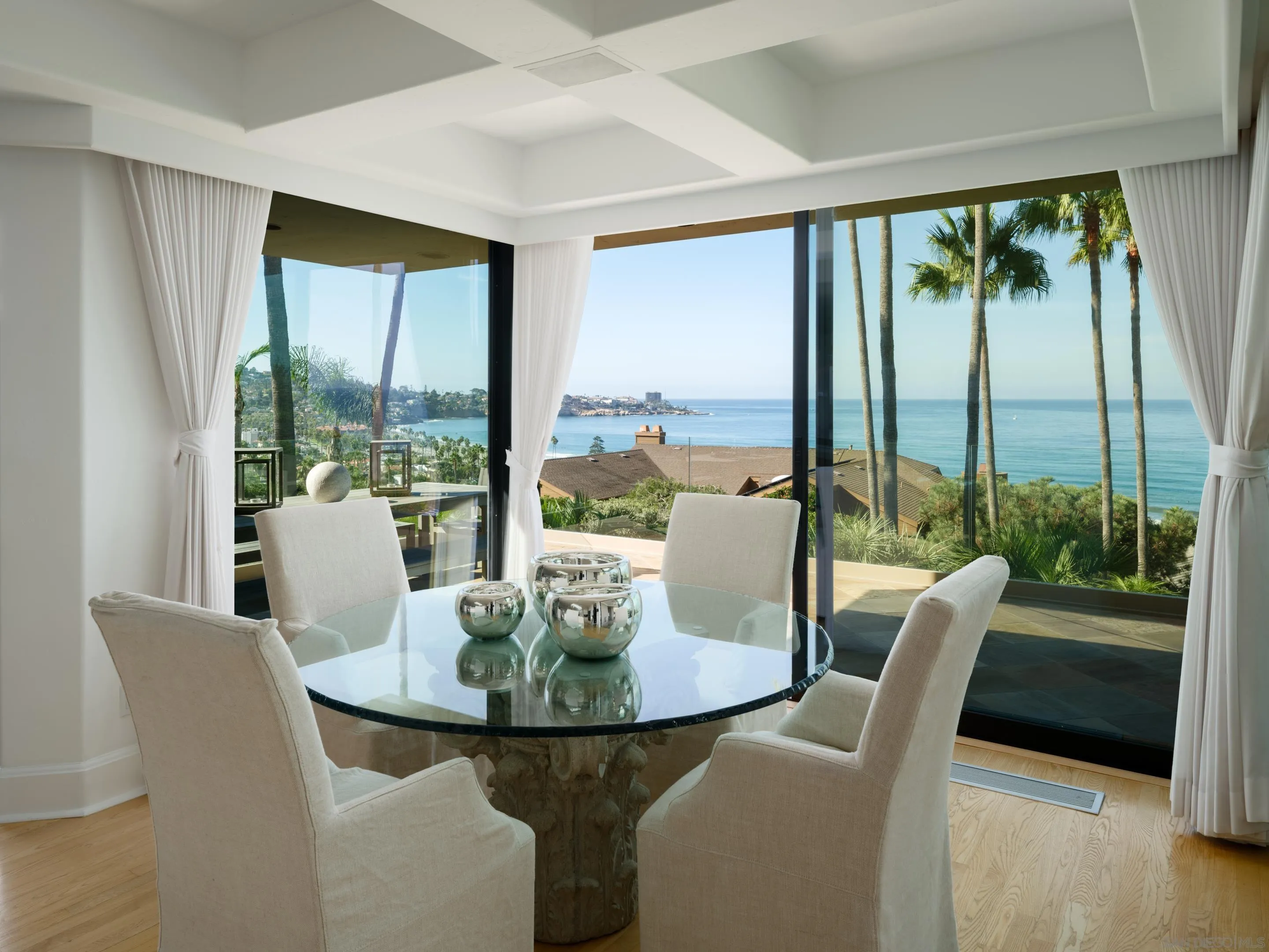8633 Ruette Monte Carlo La Jolla, CA 92037 - Photo 22 of 48 a view of a dining room with furniture large windows and wooden floor