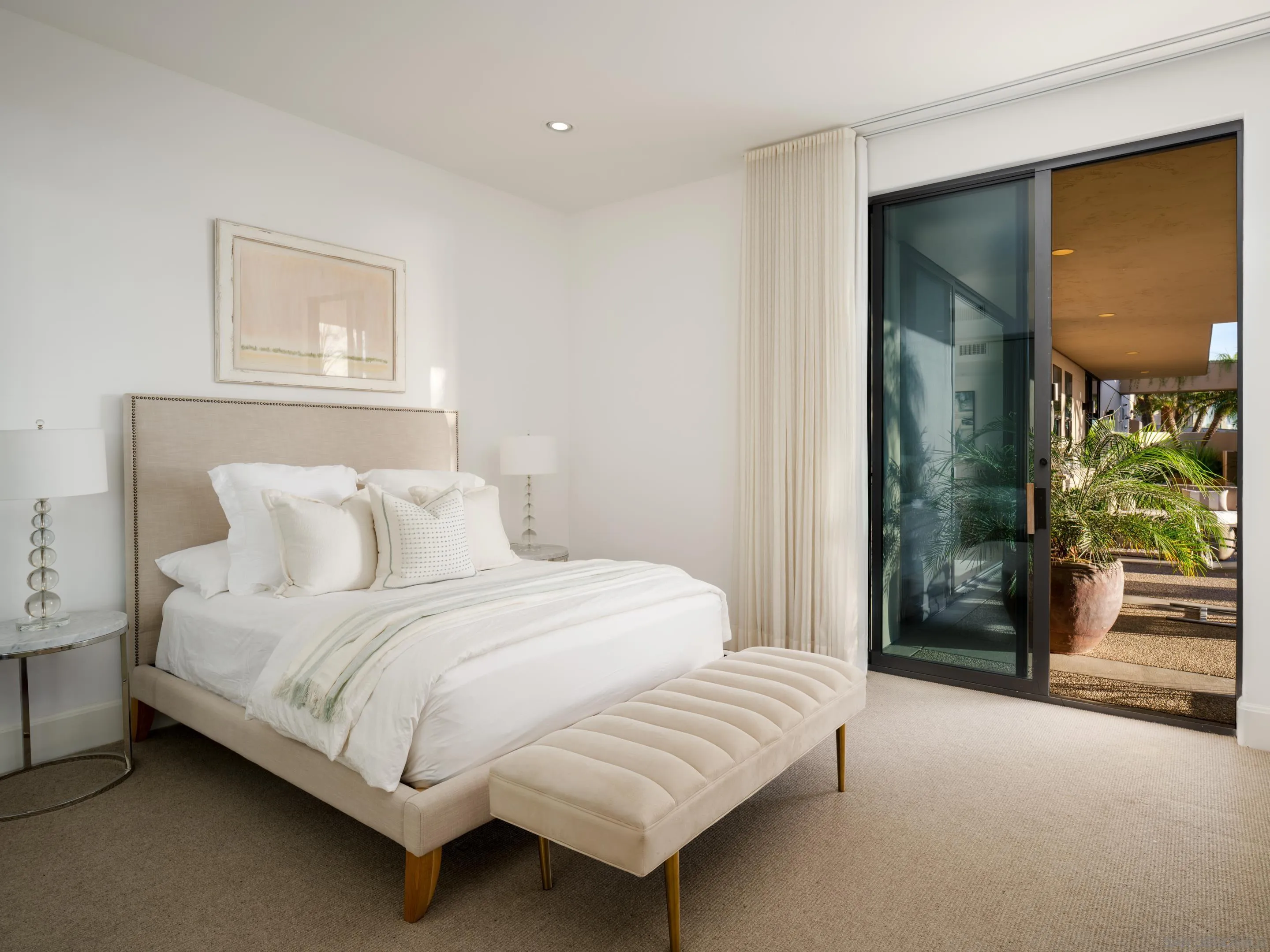 8633 Ruette Monte Carlo La Jolla, CA 92037 - Photo 41 of 48 a bedroom with a bed a mirror and a window