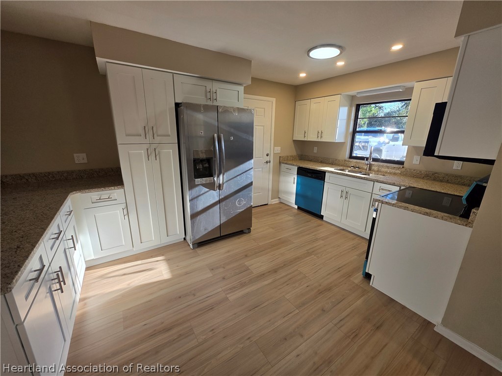 2858 North Lancaster Road Avon Park, FL 33825 - Photo 7 of 13 a kitchen with stainless steel appliances a refrigerator sink and microwave
