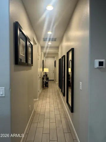 a view of a hallway with wooden floor