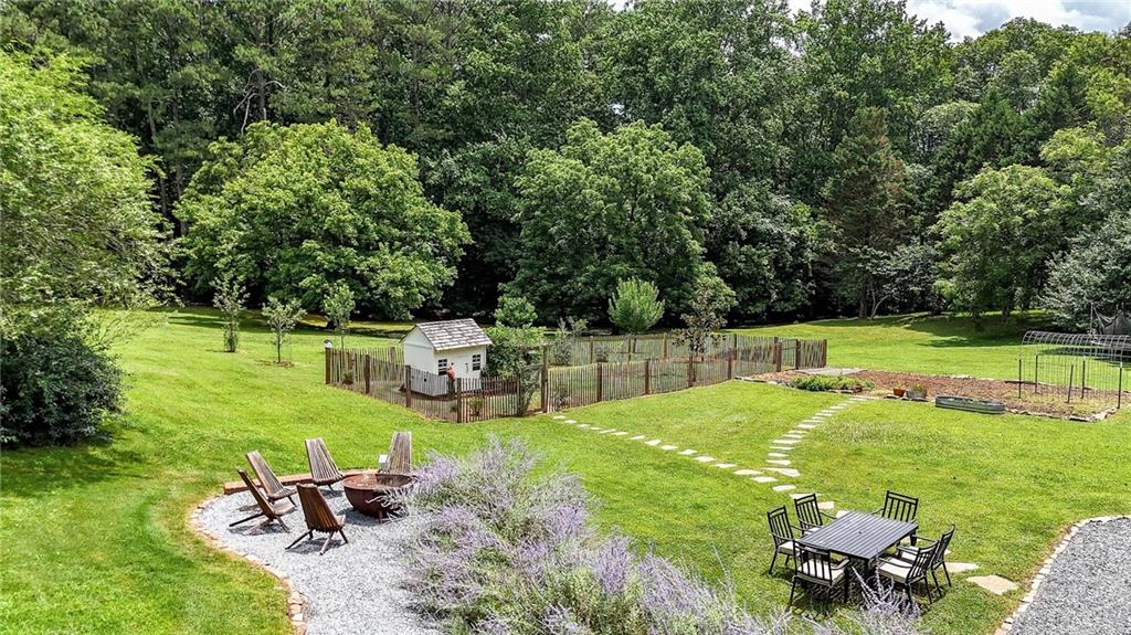 548 Tamarack Trail Canton, GA 30115 - Photo 19 of 83 a view of a swimming pool with a table and chairs