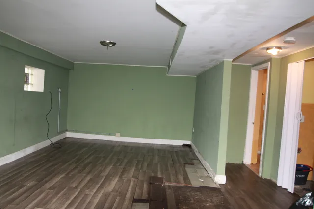 a view of a room with wooden floor and staircase