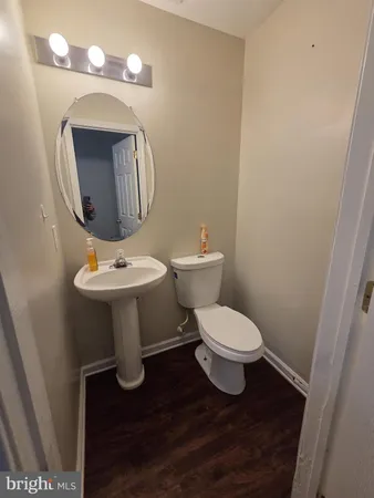a bathroom with a toilet a sink and mirror