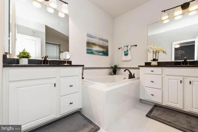 a white kitchen with cabinets and sink