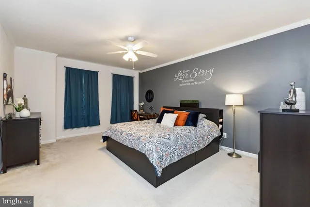 a spacious bedroom with a bed and a chandelier