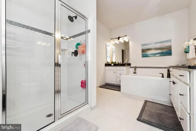 a bathroom with a tub a sink and a mirror