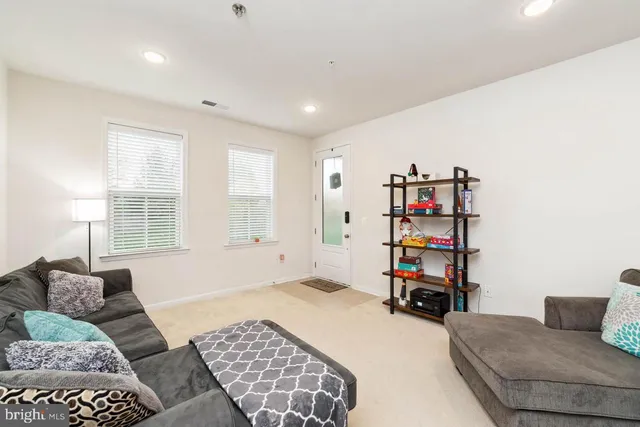 a bedroom with furniture and a book shelf