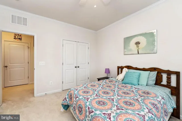 a bedroom with a bed and a painting on the wall