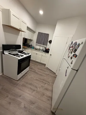 a kitchen with stainless steel appliances granite countertop a stove and a refrigerator