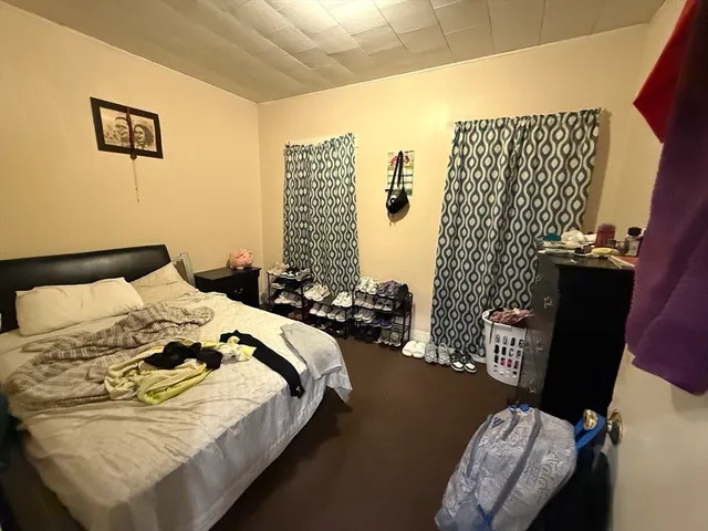 a bedroom with bed and a window