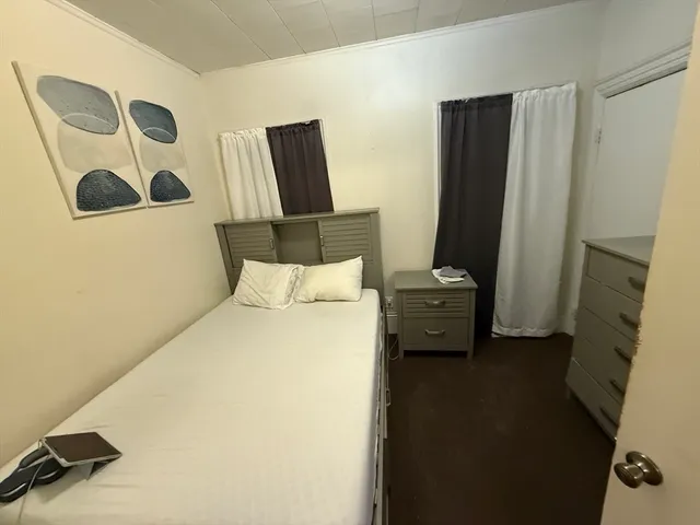 a bedroom with a bed and a mirror