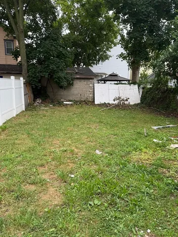 a white house that has tree in front of it