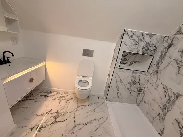 a bathroom with a toilet and a tub