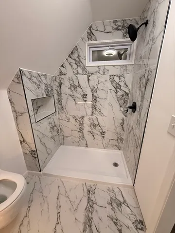 a bathroom with a bathtub and shower