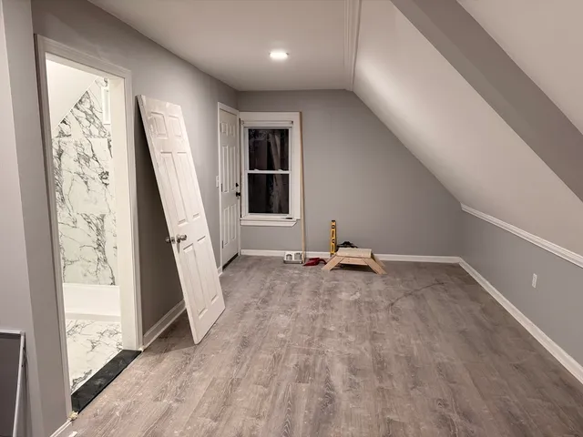 a view of a livingroom with wooden floor and stairs