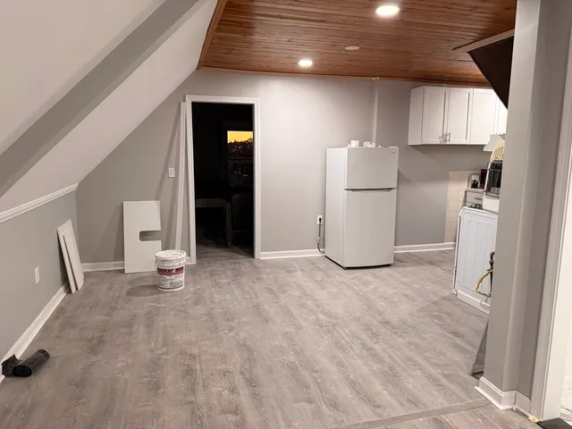 a view of a kitchen with refrigerator and cabinet