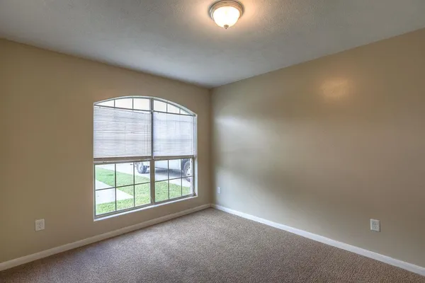 an empty room with a empty space and windows