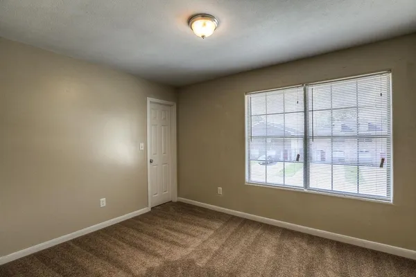 an empty room with a empty space and windows