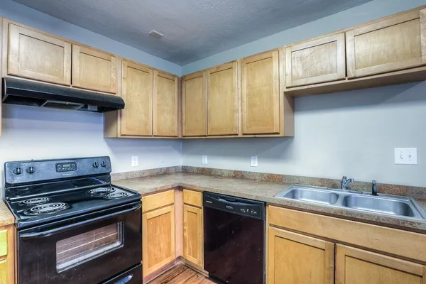 a kitchen with stainless steel appliances granite countertop a sink stove and cabinets