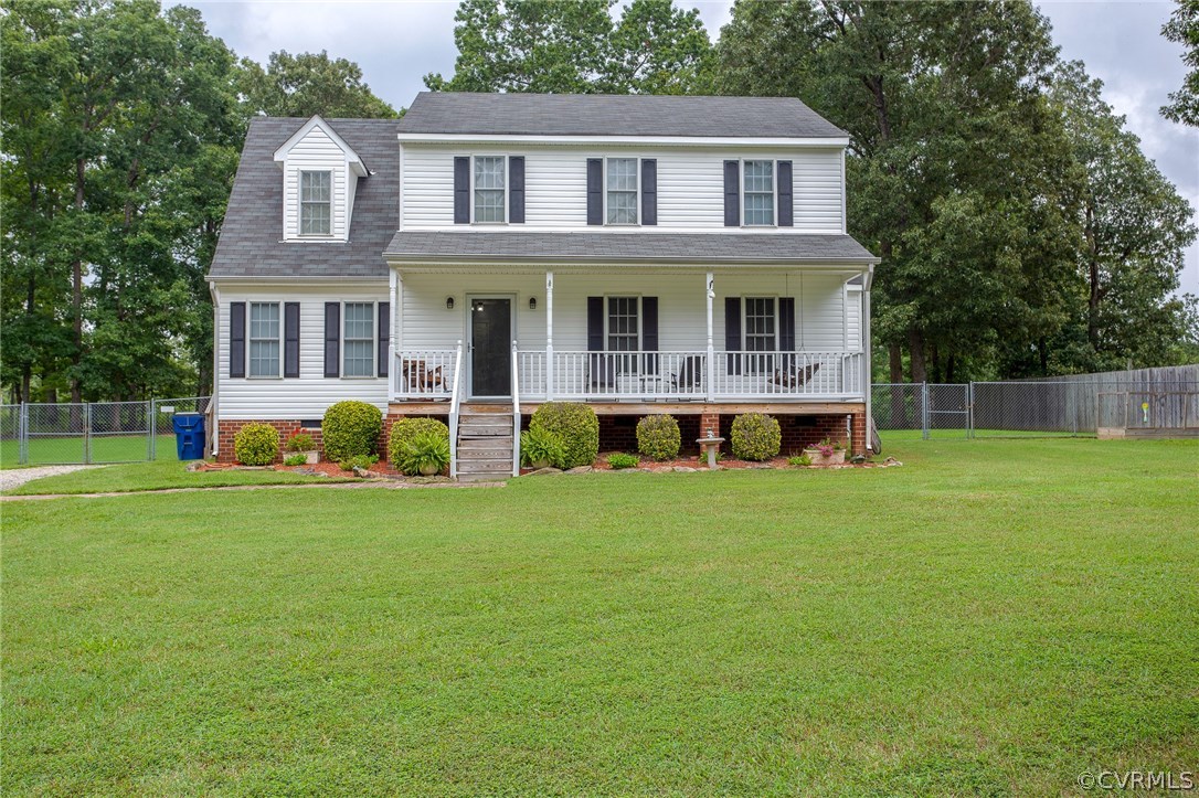 a front view of a house with a yard and trees