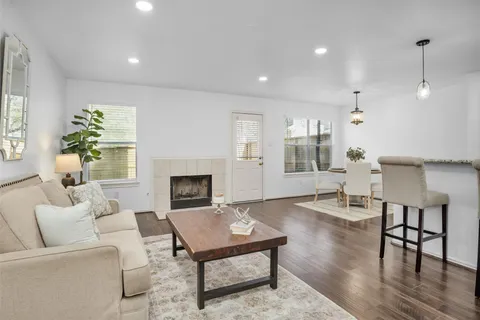a living room with furniture a fireplace and a table
