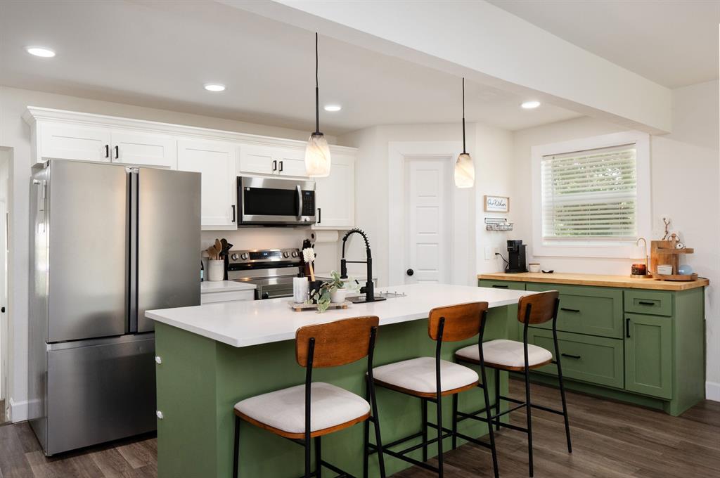 205 Oregon Avenue Azle, TX 76020 - Photo 12 of 40 Kitchen with green cabinetry, recessed lighting, and pendant lighting