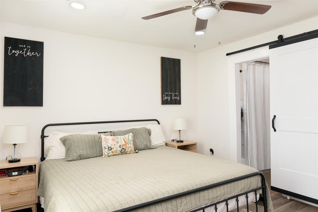 205 Oregon Avenue Azle, TX 76020 - Photo 18 of 40 Primary bedroom featuring a barn door to ensuite bathroom, recessed lighting, a ceiling fan