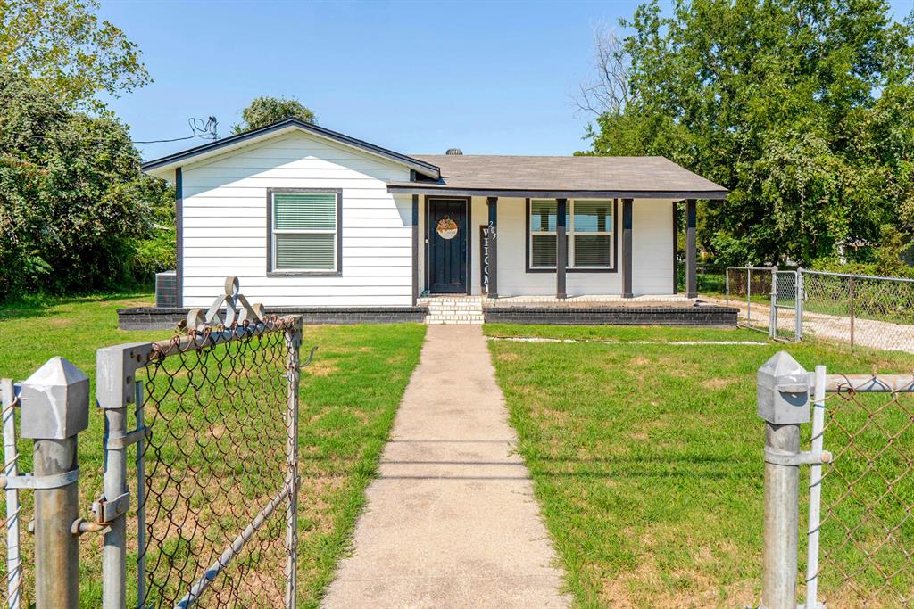 205 Oregon Avenue Azle, TX 76020 - Photo 2 of 40 Farmhouse-style home featuring a porch, a fenced front yard, and a gate