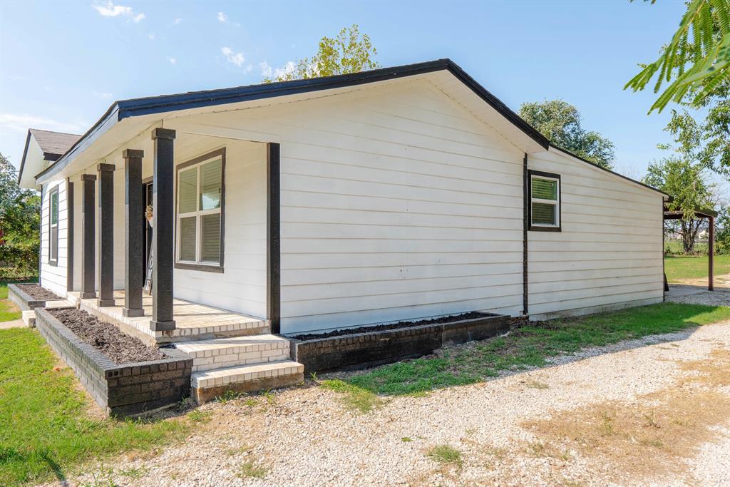 205 Oregon Avenue Azle, TX 76020 - Photo 30 of 40 View of property exterior with covered porch