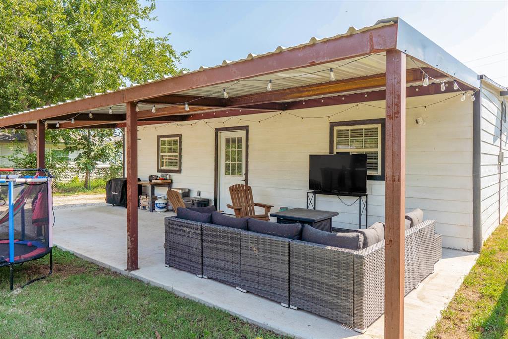205 Oregon Avenue Azle, TX 76020 - Photo 37 of 40 View of patio with a trampoline, an outdoor hangout area, and grilling area