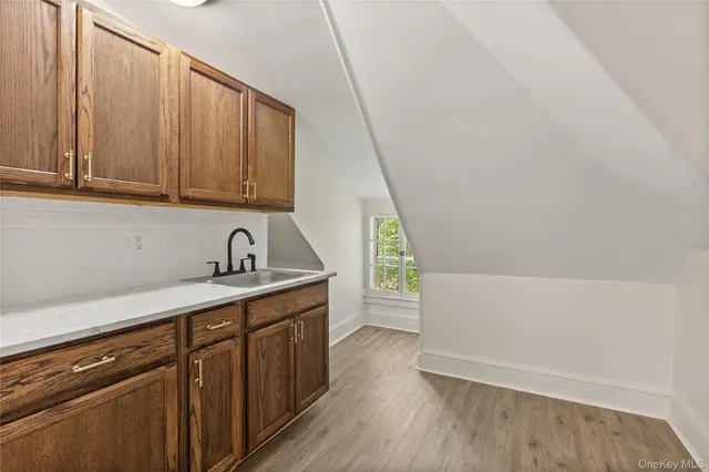 a kitchen with a sink a stove and cabinets