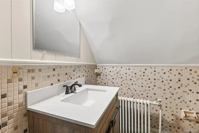a bathroom with a sink a vanity and a shower