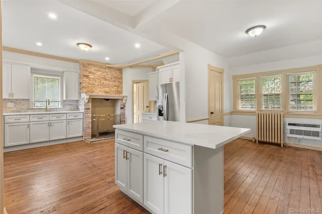 a kitchen with white cabinets and sink
