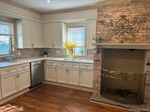 a kitchen with a sink window and cabinets