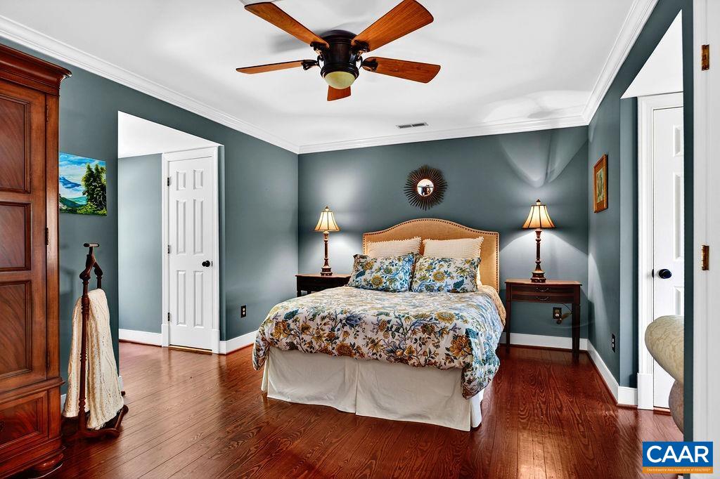 1059 Bryant Mountain Road Roseland, VA 22967 - Photo 28 of 58 a bedroom with a bed and a wooden floor