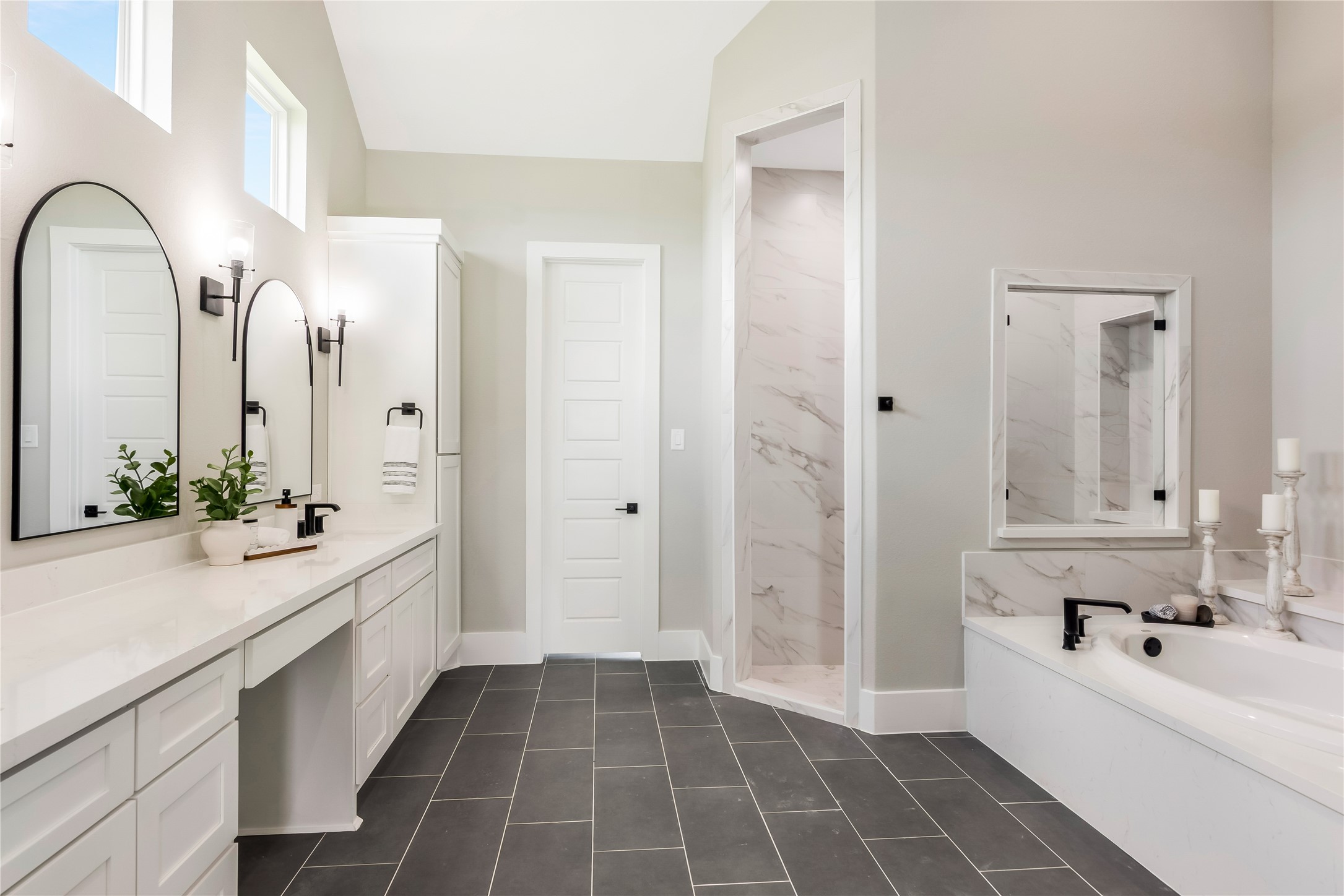 1483 Bluebonnet Ridge Drive Chappell Hill, TX 77426 - Photo 27 of 44 a large white bathroom with a double vanity sink a mirror and a bathtub