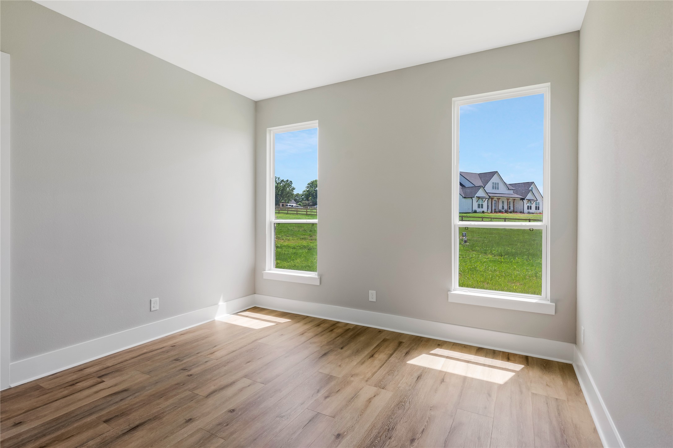 1483 Bluebonnet Ridge Drive Chappell Hill, TX 77426 - Photo 33 of 44 an empty room with wooden floor and a window