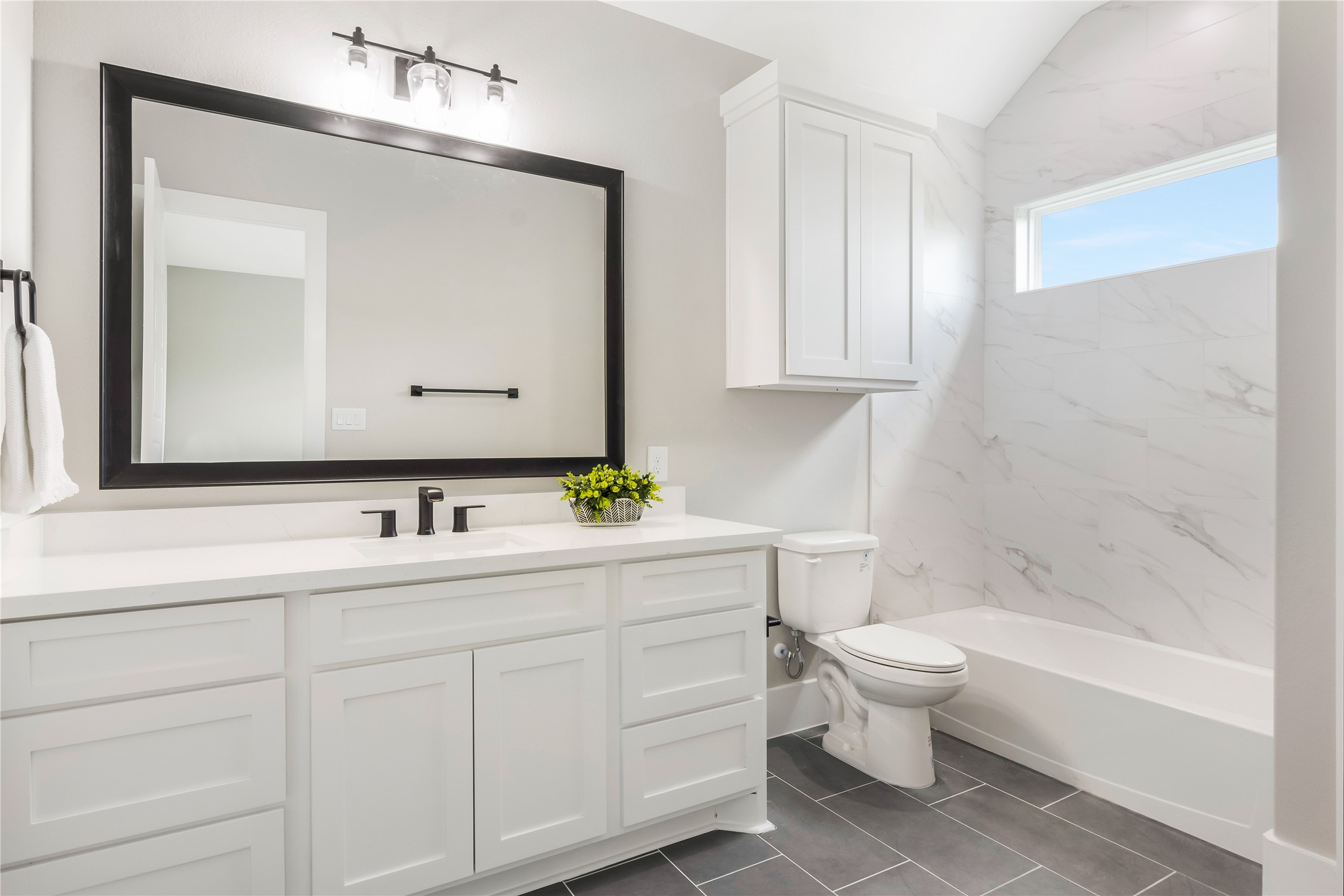 1483 Bluebonnet Ridge Drive Chappell Hill, TX 77426 - Photo 34 of 44 a bathroom with a toilet a sink a mirror a bathtub and vanity