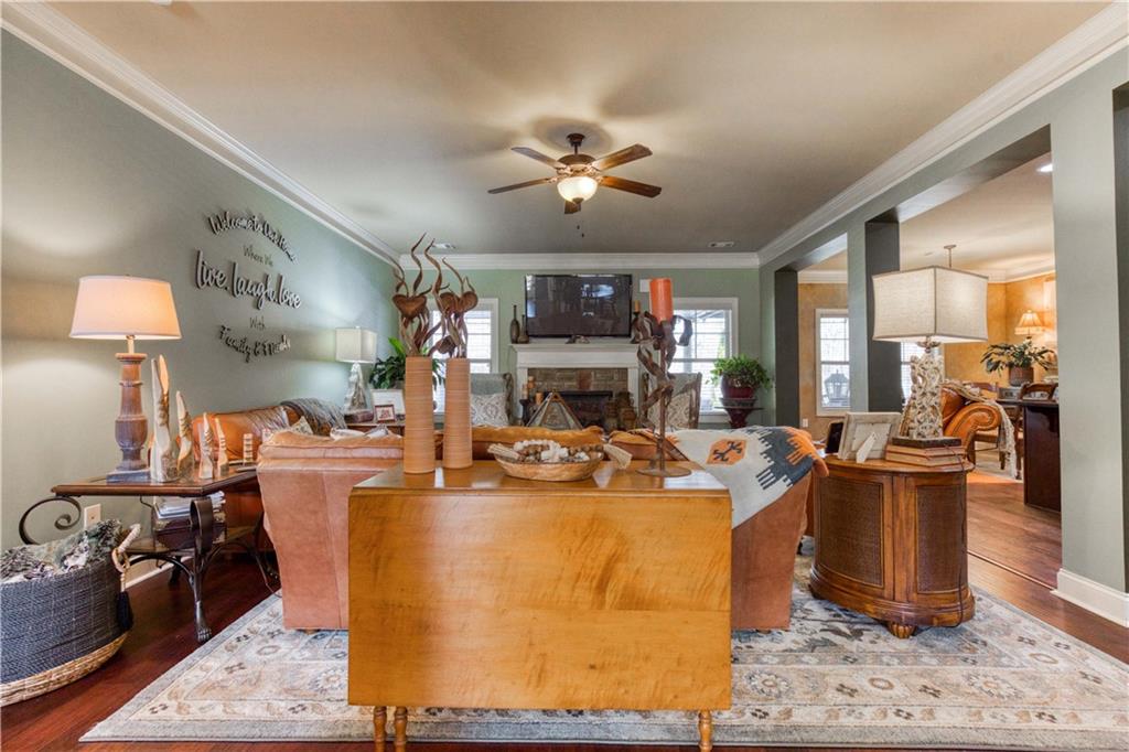 1461 Bradford Lane Monroe, GA 30656 - Photo 12 of 66 a view of a dining room with furniture a chandelier and wooden floor