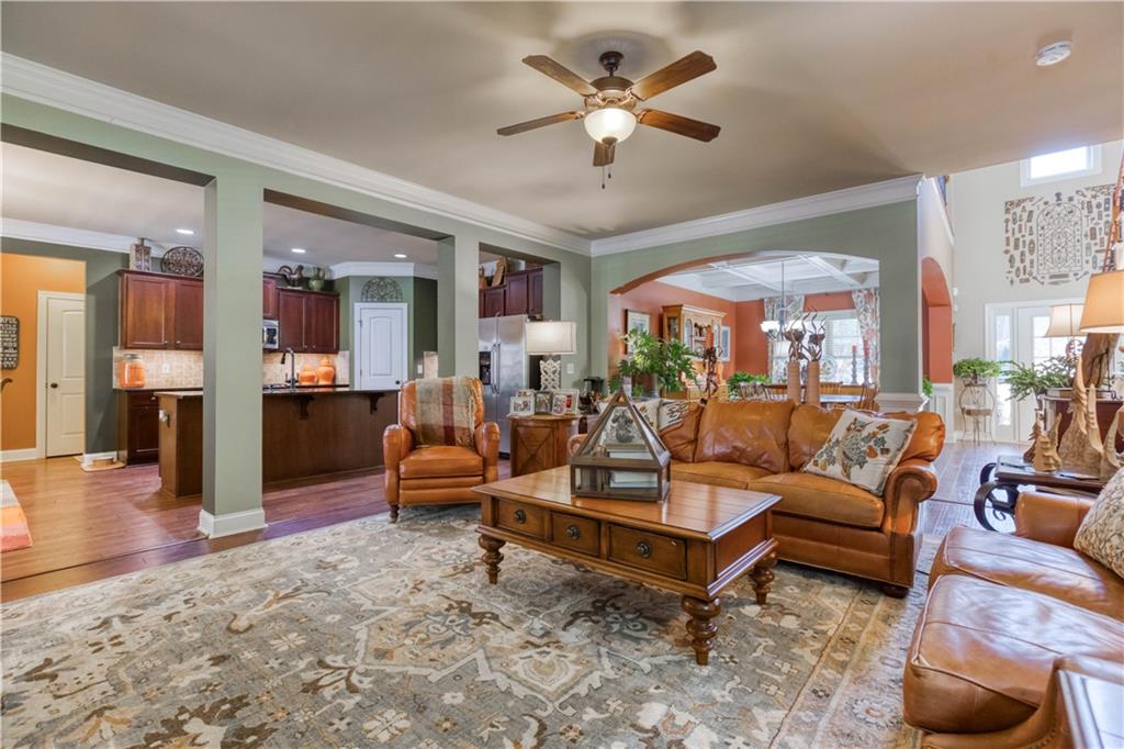 1461 Bradford Lane Monroe, GA 30656 - Photo 15 of 66 a living room with furniture a fireplace and a chandelier