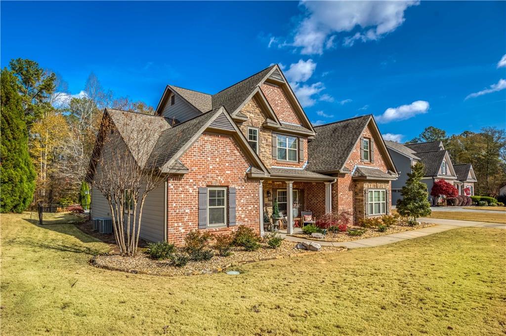 1461 Bradford Lane Monroe, GA 30656 - Photo 2 of 66 a front view of a house with a yard