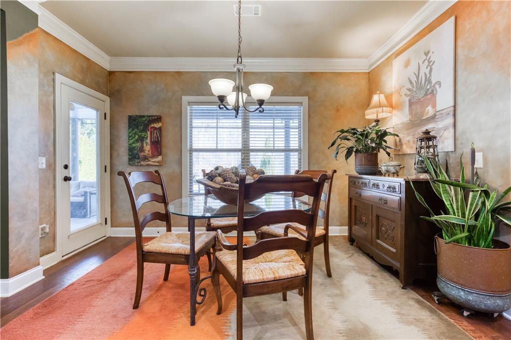 1461 Bradford Lane Monroe, GA 30656 - Photo 22 of 66 a view of a dining room with furniture window and wooden floor
