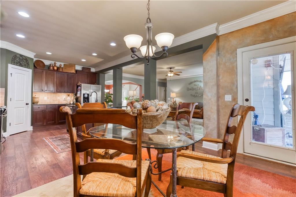 1461 Bradford Lane Monroe, GA 30656 - Photo 23 of 66 a view of a dining room with furniture and wooden floor