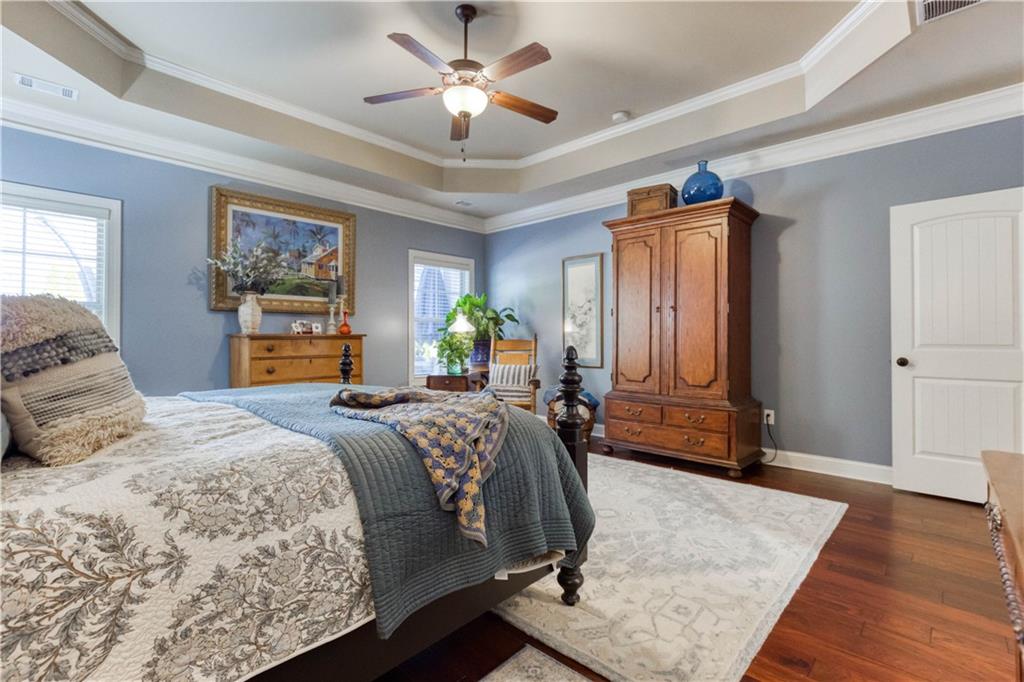 1461 Bradford Lane Monroe, GA 30656 - Photo 29 of 66 a bedroom with a bed dresser and wooden floor
