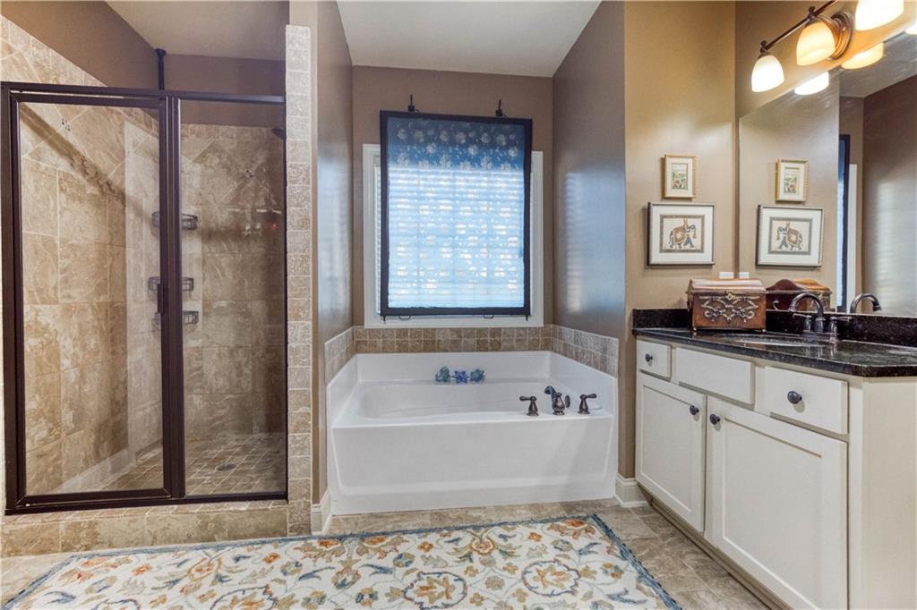 1461 Bradford Lane Monroe, GA 30656 - Photo 32 of 66 a bathroom with a bathtub a shower and a sink