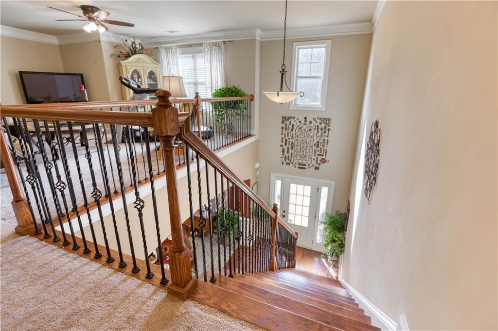 1461 Bradford Lane Monroe, GA 30656 - Photo 35 of 66 a view of a hallway with wooden floor and staircase