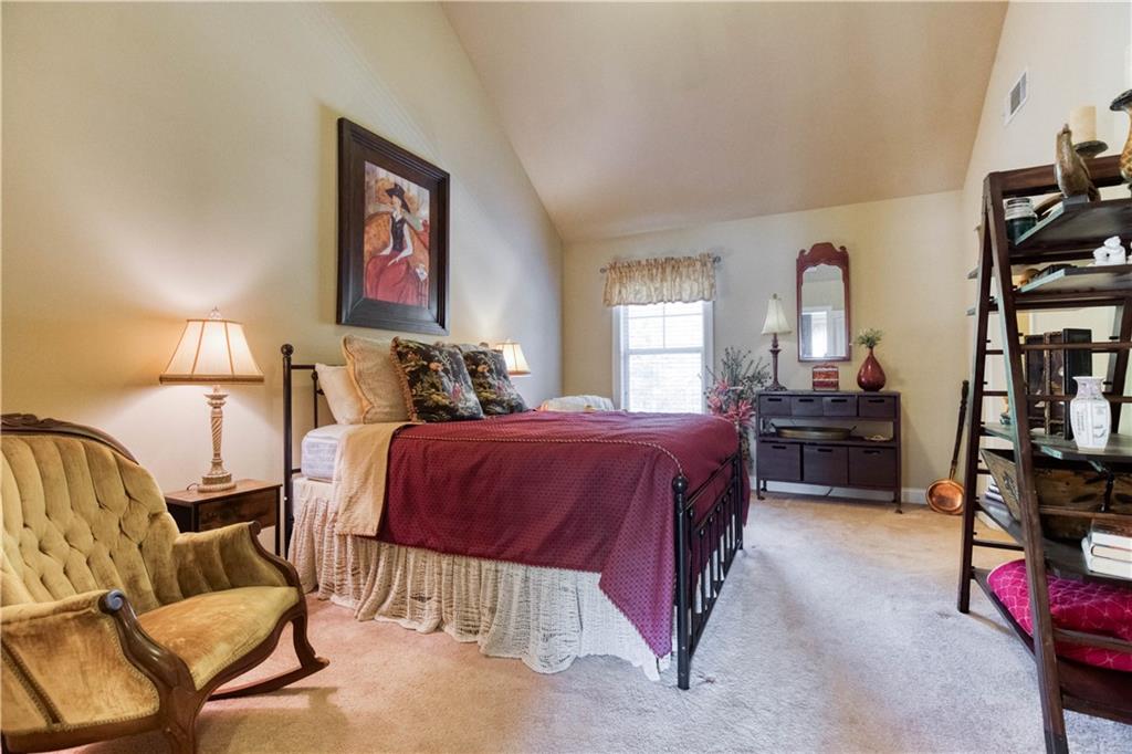 1461 Bradford Lane Monroe, GA 30656 - Photo 43 of 66 a bedroom with a bed a couch and dresser