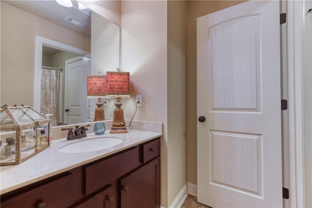 1461 Bradford Lane Monroe, GA 30656 - Photo 45 of 66 a bathroom with a sink vanity and mirror