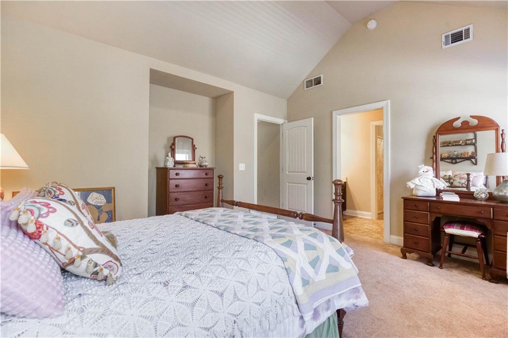 1461 Bradford Lane Monroe, GA 30656 - Photo 48 of 66 a bedroom with a bed and a dresser
