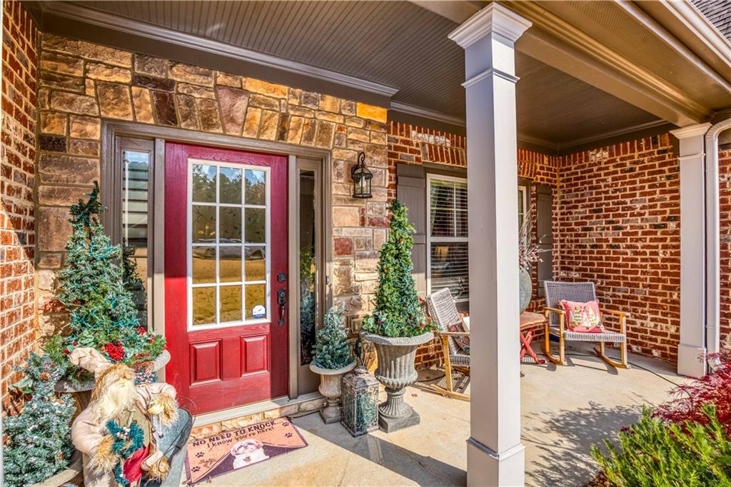 1461 Bradford Lane Monroe, GA 30656 - Photo 5 of 66 a view of porch with a table and chairs and potted plants